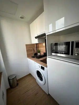 a kitchen with a washing machine and a microwave at Studio en plein cœur de Nice in Nice