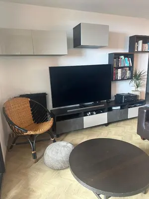a living room with a tv and a chair and a table at Cocon Azur avec vue panoramique sur mer - 4 chambres in Nice