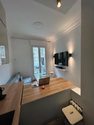 a room with a desk with a laptop on it at Chic Flat Near the Beach in Nice