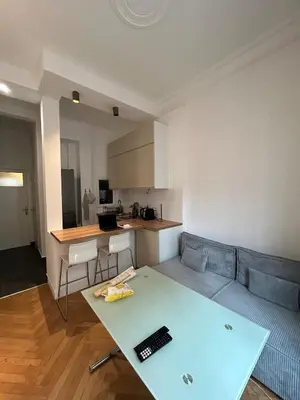 a living room with a couch and a table at Chic Flat Near the Beach in Nice