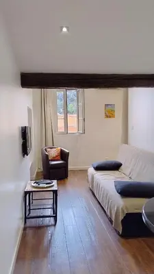 a bedroom with a bed and a couch and a table at cozy apartment port of Nice in Nice
