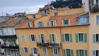 a group of buildings with windows and roofs at cozy apartment port of Nice in Nice