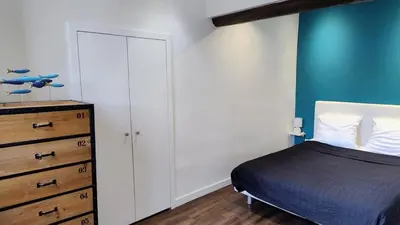 a bedroom with a bed and a dresser at cozy apartment port of Nice in Nice