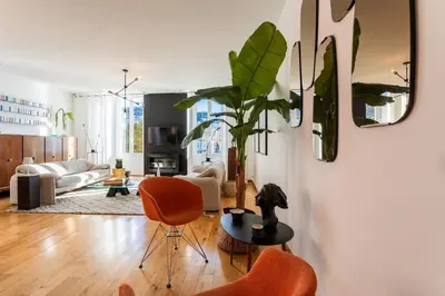 a living room with orange chairs and a table at PORT LYMPIA AP4429 By Riviera Holiday Homes in Nice
