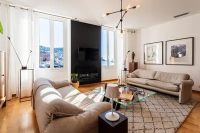 a living room with two couches and a tv at PORT LYMPIA AP4429 By Riviera Holiday Homes in Nice