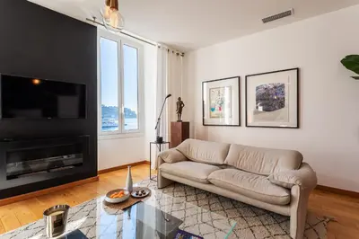 a living room with a couch and a fireplace at PORT LYMPIA AP4429 By Riviera Holiday Homes in Nice
