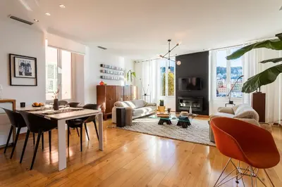 a living room with a table and chairs and a couch at PORT LYMPIA AP4429 By Riviera Holiday Homes in Nice