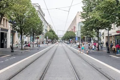 a city street with train tracks in the middle of a city at MY CASA - MEDECIN 26 - Superb Apt Suite Downtown in Nice