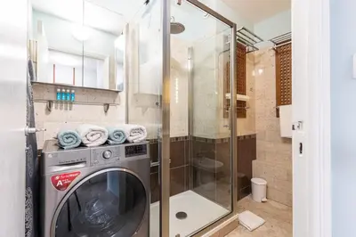 a washing machine in a bathroom with a shower at MY CASA - MEDECIN 26 - Superb Apt Suite Downtown in Nice