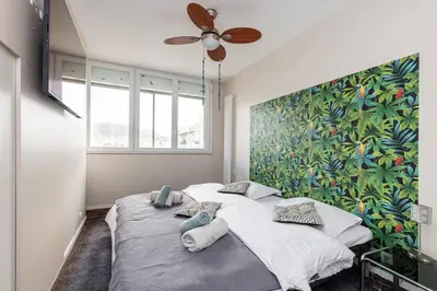 a bedroom with a large bed with a ceiling fan at MY CASA - MEDECIN 26 - Superb Apt Suite Downtown in Nice