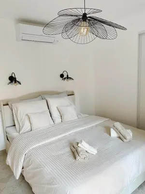 a bedroom with a white bed with towels on it at Appartement de luxe climatisé, parking & 2 balcons in Villefranche-sur-Mer