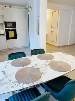 a table in a room with chairs around it at Appartement de luxe climatisé, parking & 2 balcons in Villefranche-sur-Mer