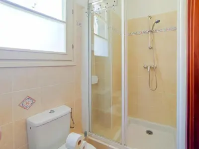 a bathroom with a shower and a toilet and a window at Grimaldi Centrale 3 Pers WiFi AC in Nice