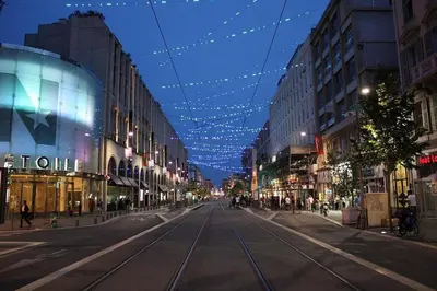 an empty city street with christmas lights and buildings at Appartement Centre Ville de Nice in Nice