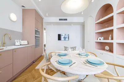 a kitchen and dining room with a table and chairs at Maison Galbani Architect-designed apartment in Nice