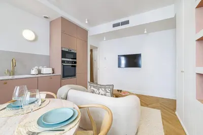 a kitchen and dining room with a table and chairs at Maison Galbani Architect-designed apartment in Nice