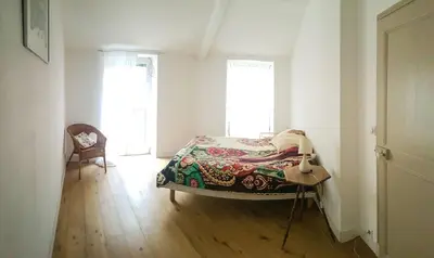 a bedroom with a bed and a chair in a room at Top floor appartement - central in Nice