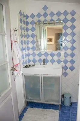 a bathroom with a sink and a mirror at Village house surrounded by greenery in La Gaude