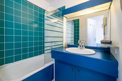 a blue bathroom with a sink and a mirror at Studio hypercentre gare in Nice