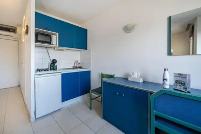 a kitchen with blue cabinets and a blue counter top at Studio hypercentre gare in Nice