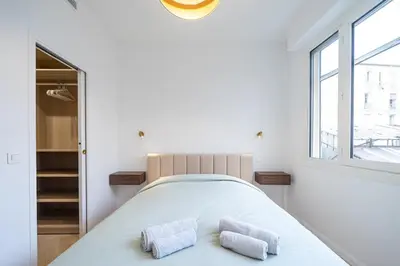 a bedroom with a bed with two towels on it at Beautiful 3 rooms, Carré d 'Or in Nice