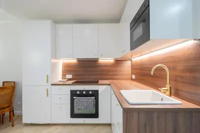 a kitchen with white cabinets and a sink at Beautiful 3 rooms, Carré d 'Or in Nice