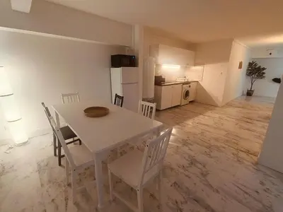 a kitchen and dining room with a table and chairs at Superbe appartement T2 de 95 m in Nice