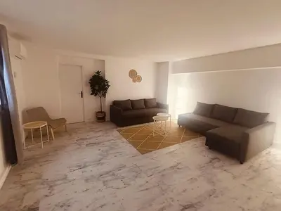 a living room with a couch and a table at Superbe appartement T2 de 95 m in Nice