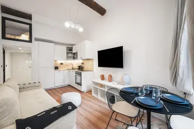 a living room with a table and a couch at Beautiful apartment, old nice in Nice
