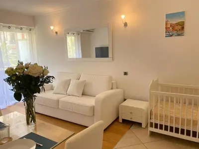 a living room with a white couch and a table at Azur Central Flat in Nice