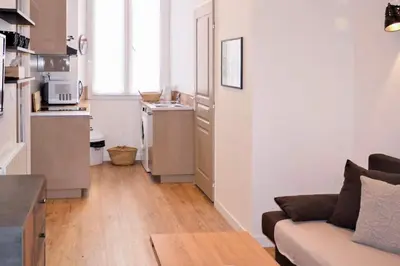 a living room with a couch and a kitchen at Barla 1 - a cosy one bedroom apartment in Nice in Nice