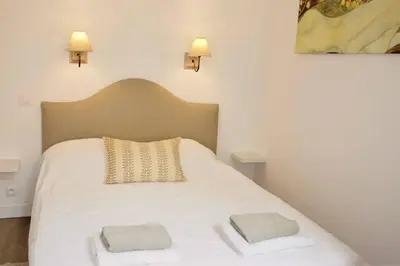 a bedroom with a white bed with two pillows on it at Barla 1 - a cosy one bedroom apartment in Nice in Nice