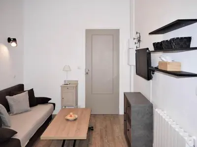 a living room with a couch and a table at Barla 1 - a cosy one bedroom apartment in Nice in Nice