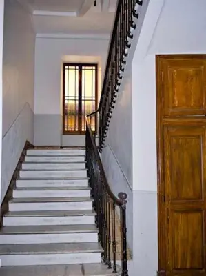 a staircase in a building with a wooden door at Barla 1 - a cosy one bedroom apartment in Nice in Nice