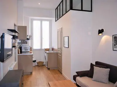 a living room with a couch and a kitchen at Barla 1 - a cosy one bedroom apartment in Nice in Nice
