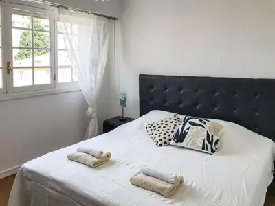 a bedroom with a large bed with two towels on it at Lympia - one bedroom apartment near the port in Nice