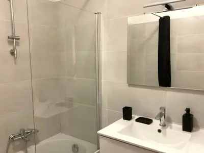 a bathroom with a shower and a sink and a tub at Lympia - one bedroom apartment near the port in Nice