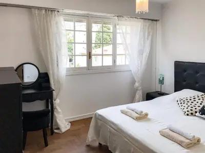 a bedroom with a bed with a mirror and a window at Lympia - one bedroom apartment near the port in Nice