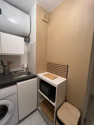 a small kitchen with a sink and a microwave at Studio Boho Chic - Proche de la mer in Nice