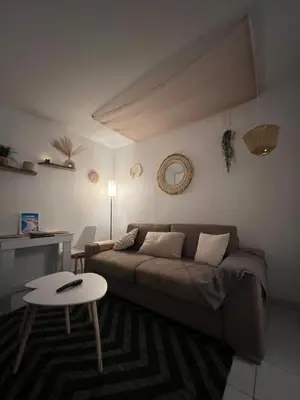 a living room with a couch and a table at Studio Boho Chic - Proche de la mer in Nice