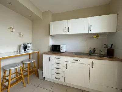 a kitchen with white cabinets and a sink and a counter at Jolie appartement à Nice in Nice