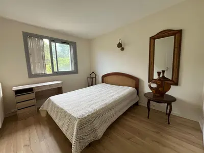 a bedroom with a bed and a mirror and a table at Jolie appartement à Nice in Nice