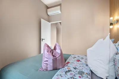 a bedroom with a bed with two pillows on it at Nice Renting - 8BONAPARTE - Architect Loft Luxury 4 Bedrooms View Place du Pin in Nice