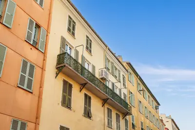 a building with a balcony on the side of it at Nice Renting - 8BONAPARTE - Architect Loft Luxury 4 Bedrooms View Place du Pin in Nice