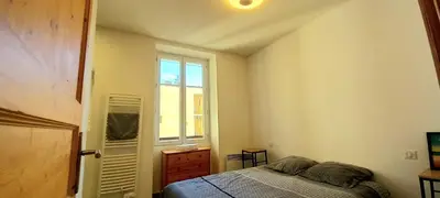 a bedroom with a bed and a window at Appartement au coeur de la ville in Nice