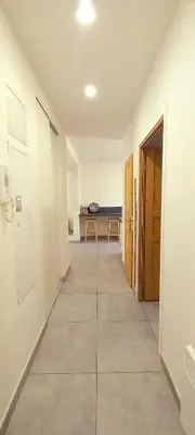 an empty hallway with a table in a room at Appartement au coeur de la ville in Nice