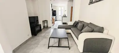 a living room with a couch and a table at Appartement au coeur de la ville in Nice