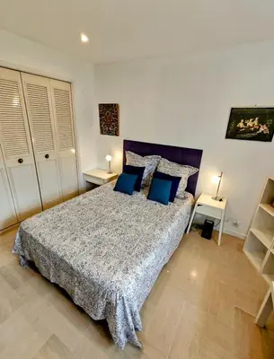 a bedroom with a large bed with blue pillows at 3P 72m2 Climatisé Vue exceptionnelle Cathédrale St Nicolas et Mer in Nice
