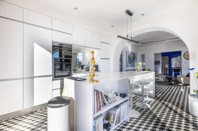 a kitchen with white cabinets and a counter in a room at Villa Margot ' Exceptional Place in Villefranche-sur-Mer