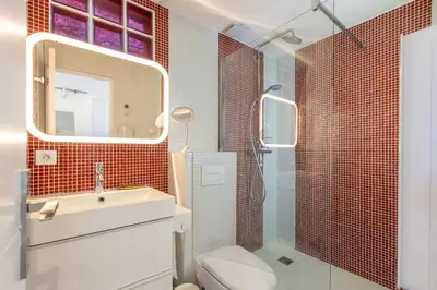 a bathroom with a toilet and a sink and a mirror at Villa Margot ' Exceptional Place in Villefranche-sur-Mer